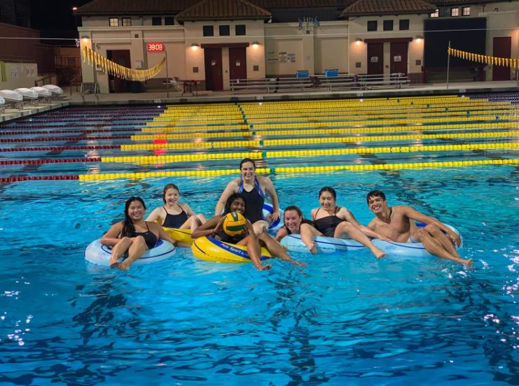 A group of students on intertubes in the pool