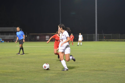 Player in white dribbling