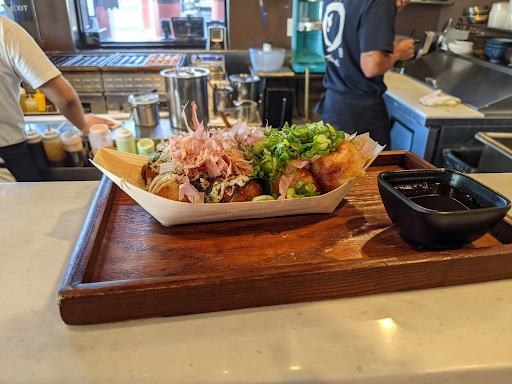 Chinese food on wooden tray.