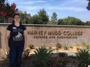 Anya in front of harvey mudd college sign