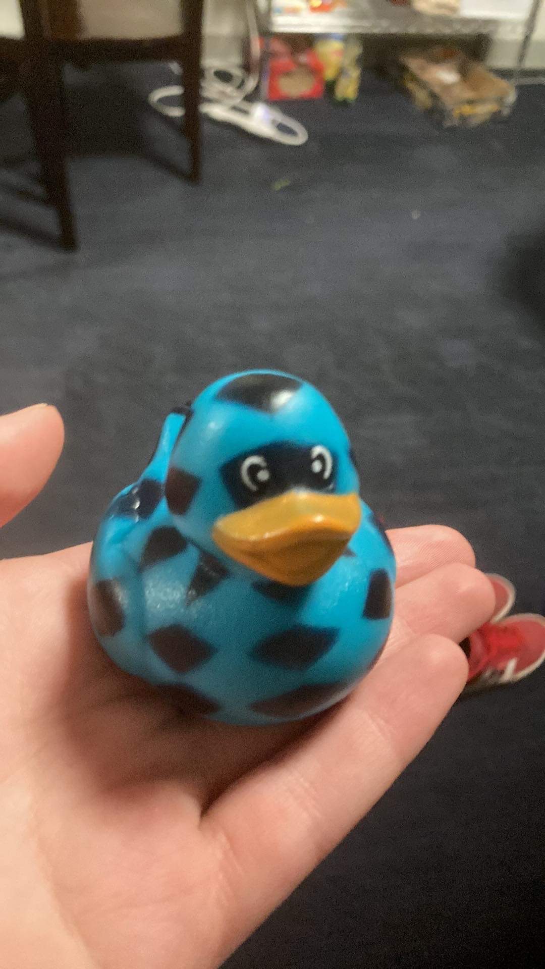 Plastic blue duck held in hand