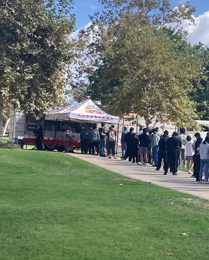 A long line of students behind a tent