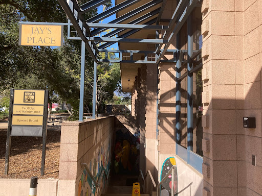 Photo of an outdoors staircase leading down with a sign reading "Jay's Place"