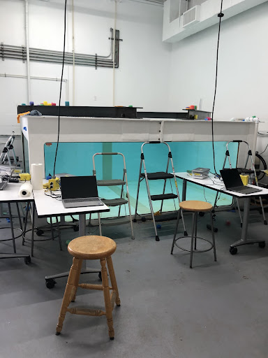 Tank in a lab with stools, computers, and chairs
