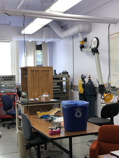 Lab space with a robot arm and compressed gas containers