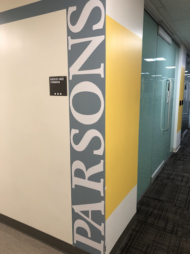 Blue paint on a wall reads "Parsons"