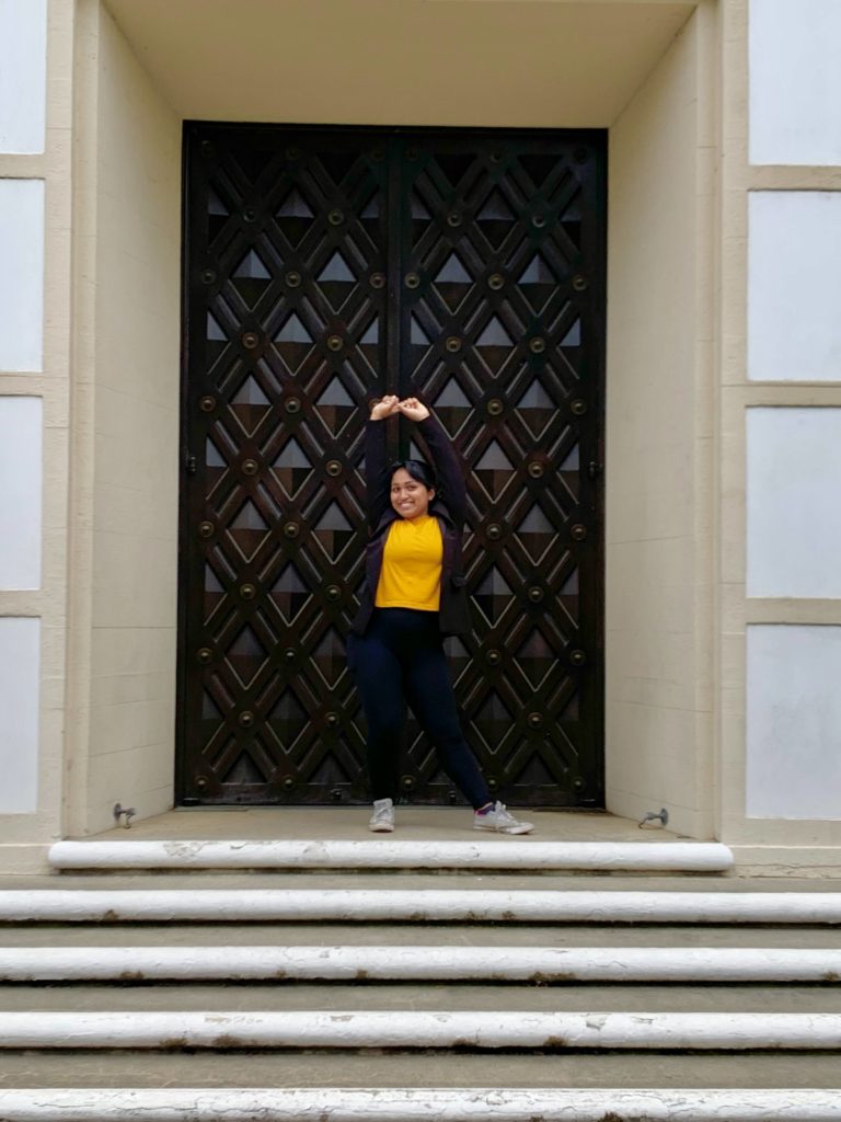 Kaanthi in front of a door