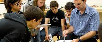 A group of students watching a professor explain something