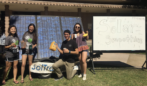  Four Mudd students pose in front of solar panels used for the smoothie cart 