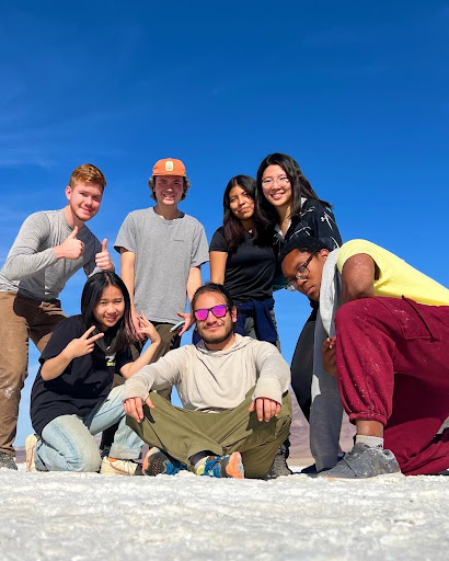 Group of students posing on a rock