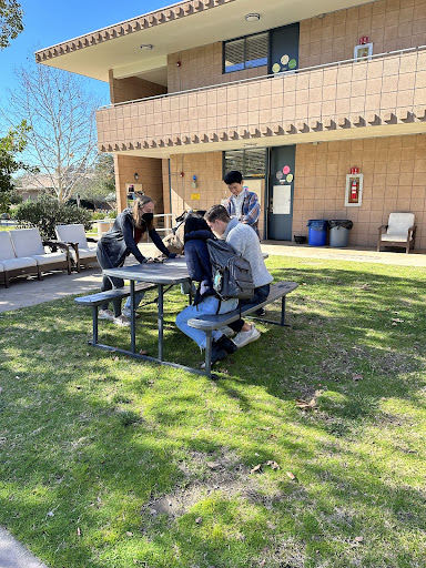 south dorm courtyard with students sitting at table