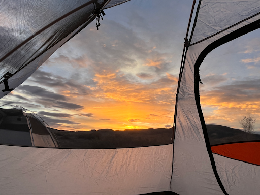 Sunrise viewed through a transparent tent wall.