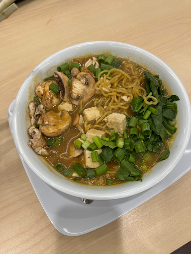 A large bowl of ramen on a plate