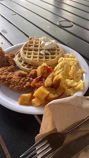 Waffles, fried chicken, potatoes, and scrambled eggs