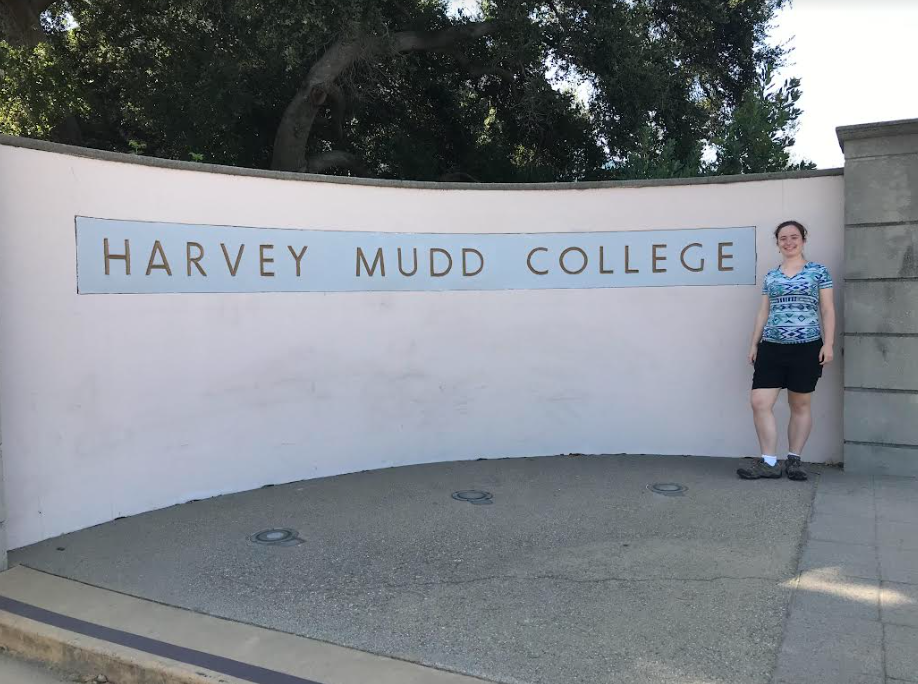 A photo of Malia with the Harvey Mudd sign during orientation in 2019.