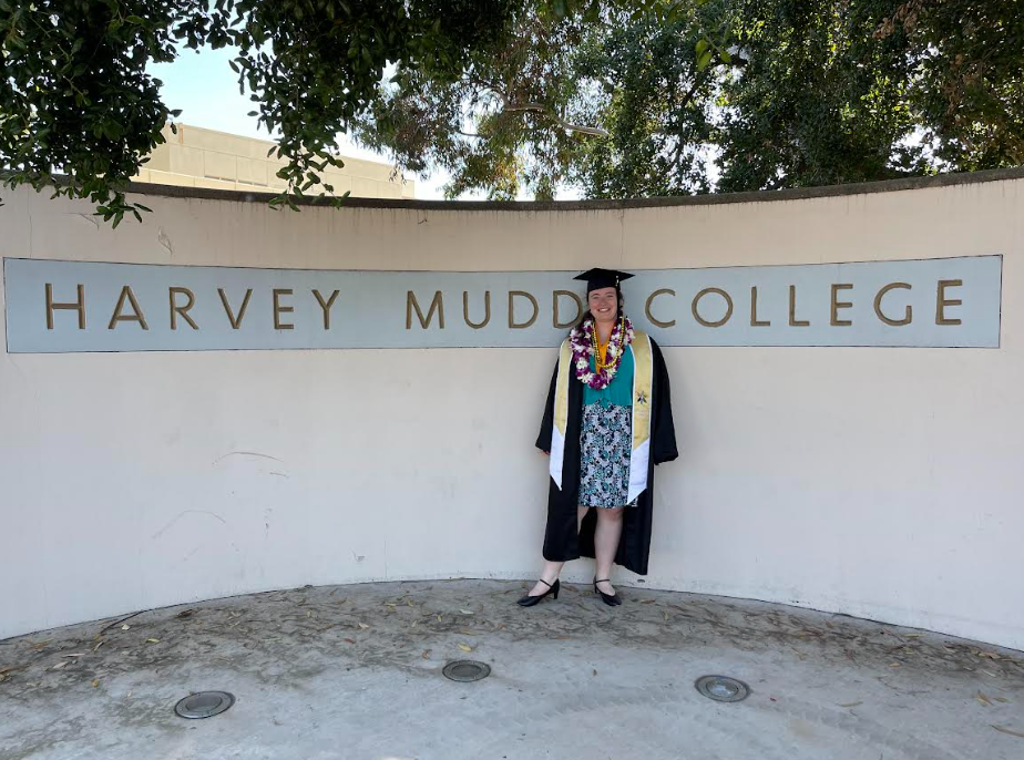 A photo of Malia with the Harvey Mudd sign after her graduation.
