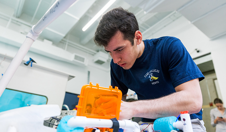 Student working on underwater robot