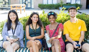 Students sitting on a bench.