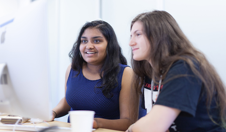 Two students sitting at a computer.