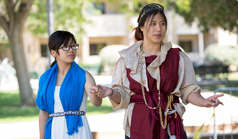 Two students in costume during a play.