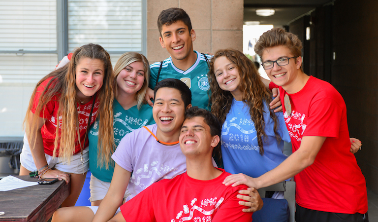 Group students embracing and posing for the camera