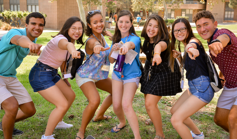 Students point at camera