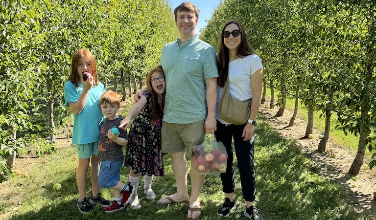 Janich and family posing in orchard