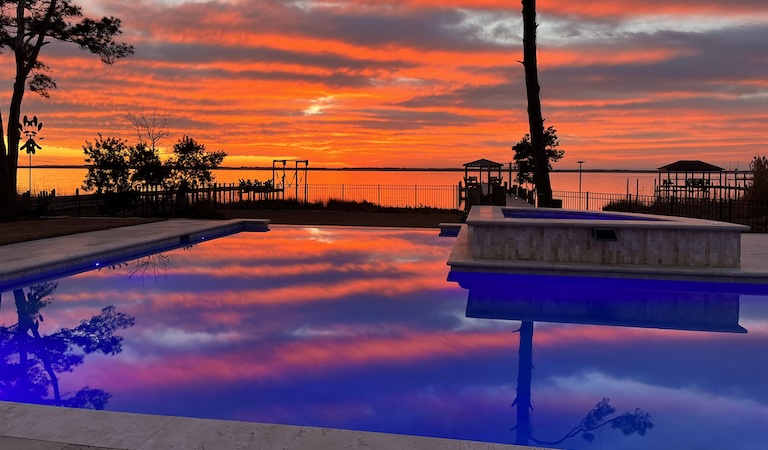 sunset over pool and ocean