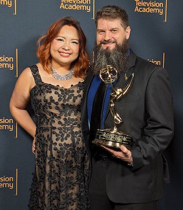 Burgess posing with Emmy
