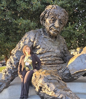 Frank-Gilchrist sitting by large bronze sculpture