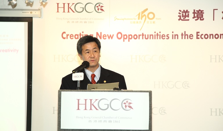 Yue speaking at podium