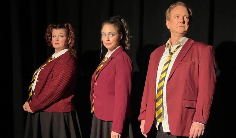 Three actors dressed in school uniforms