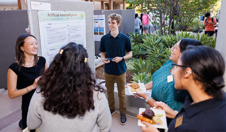 Two poster presenters address spectators