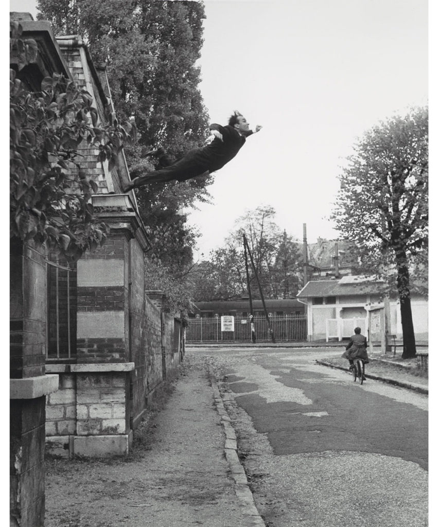 Image of man leaping off of a roof