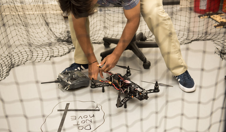 Student working on a drone