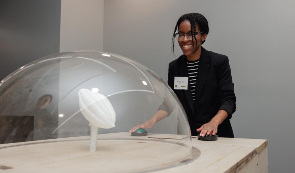 Students operates domed covered contraption