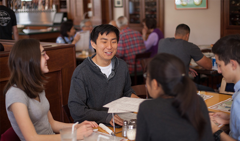 Students having a meal in the Claremont Village.