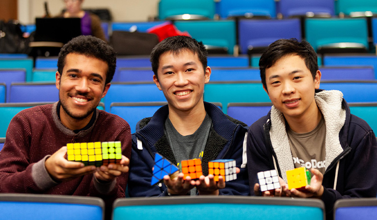 Harvey Mudd students holding up rubics cubes.