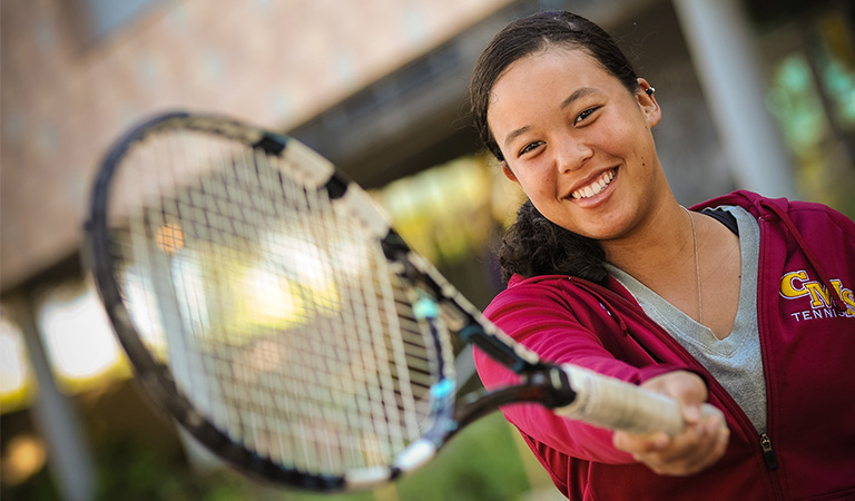 Student holding tennis racquet