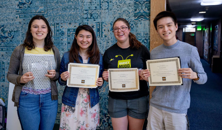 Four students pose with their awards.