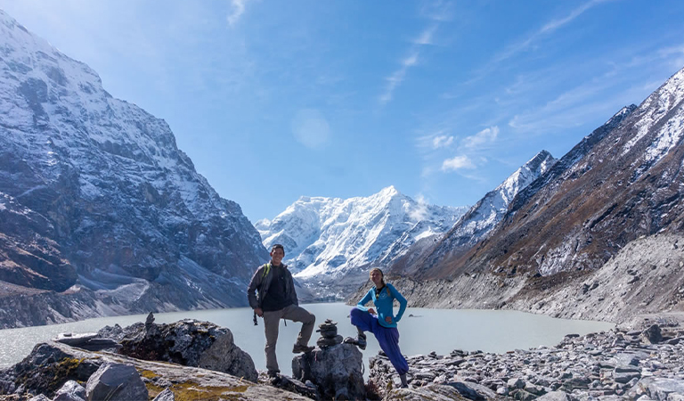 Students standing at bank of lake.