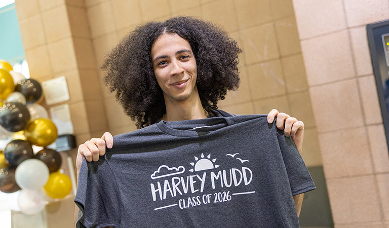 Student holding gray Class of 2026 t-shirt