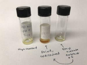 Three vials with labels written on their standing surface. Description below.