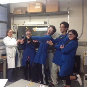 Prof Van Heuvelan and four students all in lab coats