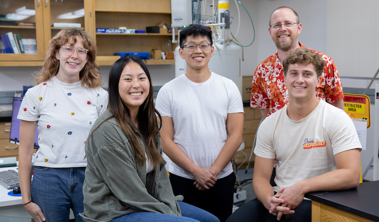 Prof. Vosburg and research students posing in a group