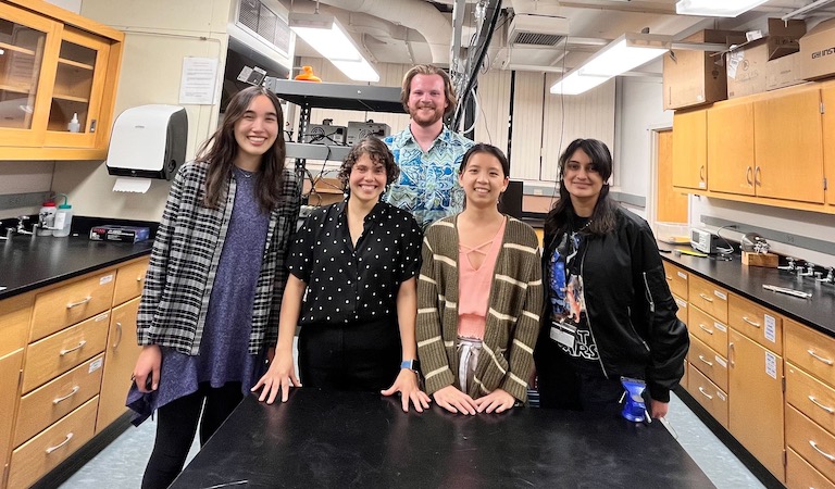 Prof. Hernandez-Castillo and her lab group standing inside a lab