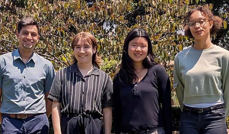 Professor Brucks and three summer research students posing outside