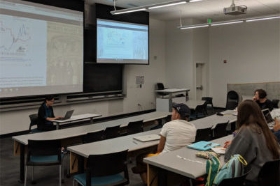 Yi Luo giving a presentation to a class