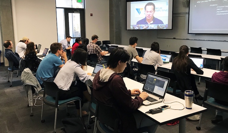 Faculty in classroom watching video presentation