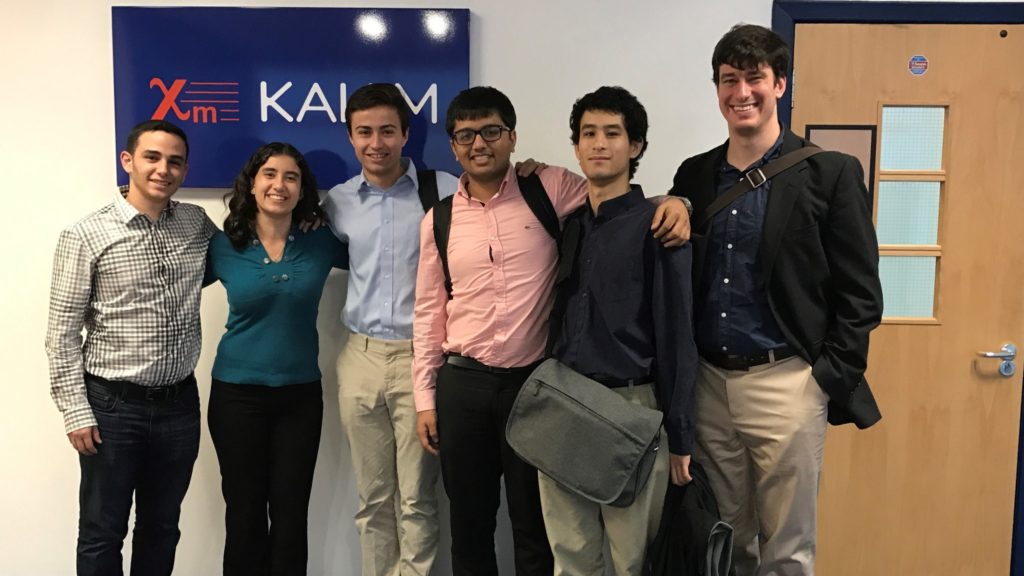 Image of a Global Clinic team, students and advisor, standing in front of Sponsor's headquarters